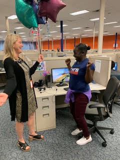 Heather D. Blease presents balloons to SaviScholar Jequetta Dean