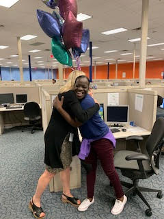 Heather D. Blease shares a hug with Jequetta Dean, the first SaviScholar